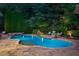 Twilight view of backyard pool and spa with waterfall features and lounge chairs for relaxation at 4304 Berkford Ne Cir, Brookhaven, GA 30319
