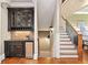 Beautiful staircase with wood treads, iron railings, and a built-in bar area at 4304 Berkford Ne Cir, Brookhaven, GA 30319