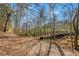 Charming walking trail with a small bridge, surrounded by lush greenery and trees at 4304 Berkford Ne Cir, Brookhaven, GA 30319