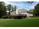 Expansive backyard featuring a large wooden deck, mature trees and lush green lawn at 5 Glenn Eagles Vw, Hiram, GA 30141