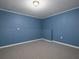 Spacious finished basement with clean blue walls and neutral carpet at 5 Glenn Eagles Vw, Hiram, GA 30141