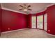 Cozy bedroom with red walls, carpet flooring, and large windows providing natural light at 5 Glenn Eagles Vw, Hiram, GA 30141