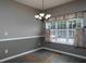 Dining room with tiled floors, decorative pendant lighting, wainscotting, and large bright windows at 5 Glenn Eagles Vw, Hiram, GA 30141