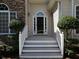 Welcoming front porch featuring a stylish front door, white railings, and charming landscaping at 5 Glenn Eagles Vw, Hiram, GA 30141
