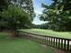Beautiful golf course view, framed by mature trees and a wooden fence at 5 Glenn Eagles Vw, Hiram, GA 30141