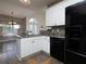 L-shaped kitchen with white cabinetry, stainless steel appliances, and views to the breakfast nook at 5 Glenn Eagles Vw, Hiram, GA 30141