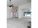 Bright living room with ceiling fan, large window, neutral walls, and arched doorways at 5 Glenn Eagles Vw, Hiram, GA 30141