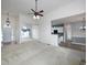 Open-concept living room with neutral walls, ceiling fan, pendant lighting, and access to the kitchen at 5 Glenn Eagles Vw, Hiram, GA 30141