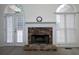 Cozy living room featuring stone fireplace with arched windows and doors providing ample light at 5 Glenn Eagles Vw, Hiram, GA 30141