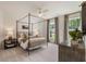 Bright bedroom features a four-poster bed, neutral tones, and large windows for natural light at 5330 Keepsake Court, Cumming, GA 30040