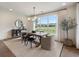 Dining room with wooden table, modern chandelier, neutral rug, and view of landscaped yard at 5330 Keepsake Court, Cumming, GA 30040