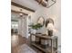 A bright entryway with wood floors, a console table with lamps, and decorative mirrors at 5330 Keepsake Court, Cumming, GA 30040