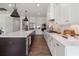 Gourmet kitchen with a large island, stainless appliances, white cabinetry, quartz countertops, and modern pendant lights at 5330 Keepsake Court, Cumming, GA 30040