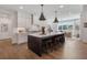 Spacious eat-in kitchen with island, stainless appliances, hardwood floors, and modern pendant lighting at 5330 Keepsake Court, Cumming, GA 30040