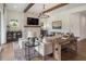 Bright living room boasts stone fireplace, wood beams, and modern chandelier at 5330 Keepsake Court, Cumming, GA 30040