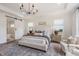 Well-lit main bedroom boasts an ensuite bathroom and comfy sitting area at 5330 Keepsake Court, Cumming, GA 30040