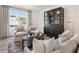 Comfortable sitting room with a black display cabinet and neutral furniture at 5330 Keepsake Court, Cumming, GA 30040