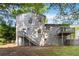 Exterior shot of the home with a two-tiered deck, stairs and door leading out to the yard at 6192 Holiday Blvd, Forest Park, GA 30297