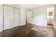 This bedroom has wood floors, with a bathroom and closet just off to the side at 6192 Holiday Blvd, Forest Park, GA 30297