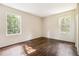 Sun-filled bedroom with hardwood floors and two windows at 6192 Holiday Blvd, Forest Park, GA 30297