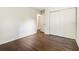 Bedroom featuring hardwood flooring, closet space and neutral paint at 6192 Holiday Blvd, Forest Park, GA 30297