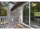 This deck has wood floors with a rail and leads to an exterior sliding glass door at 6192 Holiday Blvd, Forest Park, GA 30297