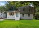 Charming home featuring a well-manicured lawn, updated two-tone paint, and a inviting front entrance at 6192 Holiday Blvd, Forest Park, GA 30297