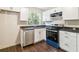 Modern kitchen featuring sleek black countertops, white cabinetry, and new stainless steel appliances at 6192 Holiday Blvd, Forest Park, GA 30297