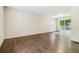Spacious living room boasts hardwood floors and a sliding glass door leading to the outside at 6192 Holiday Blvd, Forest Park, GA 30297