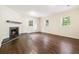 Bright living room featuring a fireplace, hardwood floors and multiple windows at 6192 Holiday Blvd, Forest Park, GA 30297