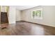 Inviting living room featuring a bay window, hardwood floors and a staircase at 6192 Holiday Blvd, Forest Park, GA 30297
