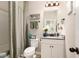 Clean bathroom with a vanity, a mirror, and a shower with a gray patterned curtain at 157 Donovan Ave, Locust Grove, GA 30248