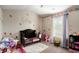 Charming bedroom with a crib, rocking horse, and whimsical decor for a cozy atmosphere at 157 Donovan Ave, Locust Grove, GA 30248