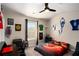 A bedroom with sports decor, featuring a fan, window, desk and bed at 157 Donovan Ave, Locust Grove, GA 30248