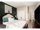 Tastefully decorated bedroom featuring a cozy bed, dark accent wall, and ample natural light at 157 Donovan Ave, Locust Grove, GA 30248