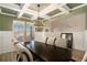 Elegant dining room with coffered ceilings, modern chandelier, and natural light at 157 Donovan Ave, Locust Grove, GA 30248