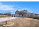 Beautiful two-story home featuring a three-car garage and manicured front yard on a sunny day at 157 Donovan Ave, Locust Grove, GA 30248