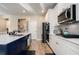 Bright kitchen boasts white cabinets, stainless steel appliances, and a large island with countertop seating at 157 Donovan Ave, Locust Grove, GA 30248