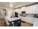 Modern kitchen features white cabinets, stainless steel appliances, an island with countertop seating at 157 Donovan Ave, Locust Grove, GA 30248