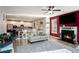 Bright living room featuring a fireplace, hardwood floors, and an open view to the kitchen at 157 Donovan Ave, Locust Grove, GA 30248
