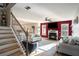 Bright living room with fireplace, large windows, ceiling fan, and wood-look floors at 157 Donovan Ave, Locust Grove, GA 30248