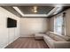 Living room with recessed lighting, gray accent wall, and comfortable beige seating at 157 Donovan Ave, Locust Grove, GA 30248