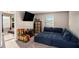 Living area featuring comfortable blue seating, neutral carpet and plenty of storage at 157 Donovan Ave, Locust Grove, GA 30248