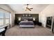 Main bedroom with vaulted ceiling, dark accent wall, and lots of natural light at 157 Donovan Ave, Locust Grove, GA 30248