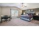 Main bedroom with vaulted ceiling, dark accent wall, and lots of natural light at 157 Donovan Ave, Locust Grove, GA 30248
