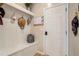 Mudroom features a built-in bench with storage, coat hooks and a neutral color palette at 157 Donovan Ave, Locust Grove, GA 30248