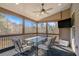 Cozy screened porch with a dining table, fan, and outdoor television for entertaining at 157 Donovan Ave, Locust Grove, GA 30248