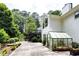 Spacious backyard with a greenhouse and patio, ideal for gardening and outdoor entertaining at 3548 Liberty Ln, Marietta, GA 30062