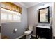Charming bathroom with dark vanity, a window with shutter blinds and neutral colored wall at 3548 Liberty Ln, Marietta, GA 30062