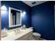Stylish bathroom with navy walls, white vanity with sink, and modern lighting fixtures at 3548 Liberty Ln, Marietta, GA 30062